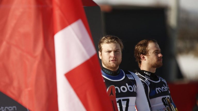 Switzerland's Niels Hintermann, left, and Canada's Cameron Alexander celebrate on the podium after winning with equal time of an alpine ski, World Cup men's downhill, in Kvitfjell, Norway, Friday, March 4, 2022. (Gabriele Facciotti/AP)