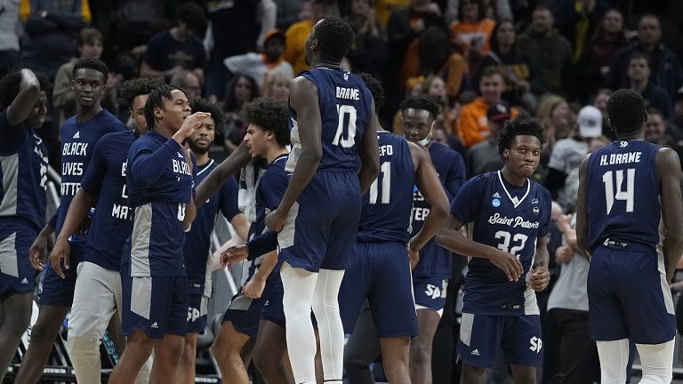 Saint Peter's players celebrate after defeating Murray State in a college basketball game in the second round of the NCAA tournament, Saturday, March 19, 2022, in Indianapolis. (AP Photo/Darron Cummings)