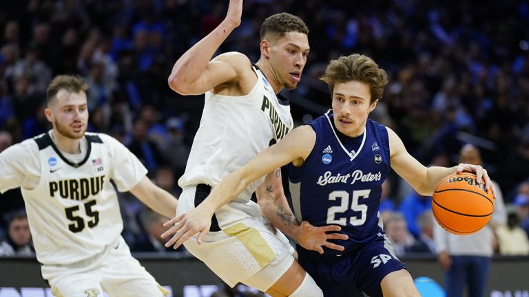 Saint Peter's Doug Edert, right, tries to get past Purdue's Mason Gillis during the first half of a college basketball game in the Sweet 16 round of the NCAA tournament, Friday, March 25, 2022, in Philadelphia. (AP Photo/Matt Rourke)