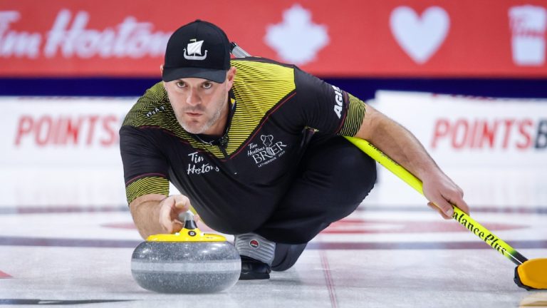 Team New Brunswick third Darren Moulding makes a shot as he plays Team Canada at the Tim Hortons Brier in Lethbridge, Alta., Saturday, March 5, 2022. (Jeff McIntosh/CP)