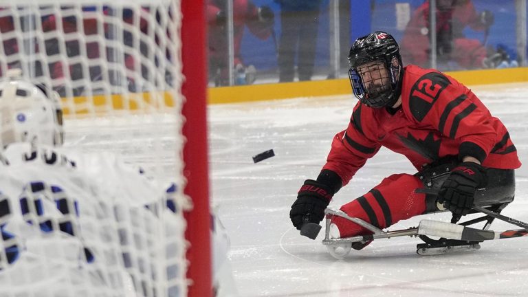 Greg Westlake of Canada attempts a shot at South Korea's goal during their para ice hockey semifinal match at the 2022 Winter Paralympics, Friday, March 11, 2022, in Beijing. (AP Photo/Dita Alangkara)