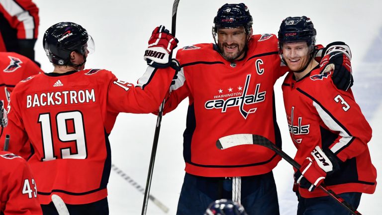 Washington Capitals left wing Alex Ovechkin, center, celebrates with center Nicklas Backstrom, left, and defenseman Nick Jensen after scoring the winning goal against the Buffalo Sabres during the shootout of an NHL hockey game. (Adrian Kraus/AP)