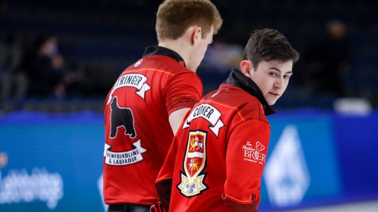 Team Newfoundland and Labrador alternate Nicholas Codner, right, walks with lead Ben Stringer during a practice session at the Tim Hortons Brier in Lethbridge, Alta., Monday, March 7, 2022. (Jeff McIntosh/CP)
