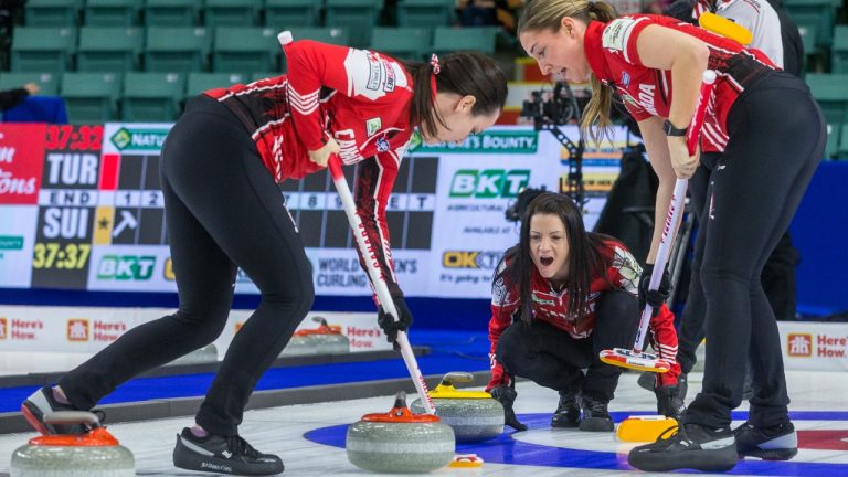 Canada skip Kerri Einarson yells directions while third Val Sweeting, left, and lead Briane Meilleur sweep in front of a stone entering the house at CN Centre on Monday afternoon during at the Women's World Curling in Prince George, B.C., Monday, March 21, 2022. (James Doyle/CP)