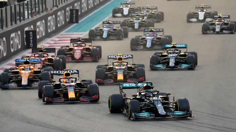 Mercedes driver Lewis Hamilton of Britain in leads Red Bull driver Max Verstappen of the Netherlands at the start of the Formula One Abu Dhabi Grand Prix in Abu Dhabi, United Arab Emirates, Sunday, Dec. 12. 2021. Max Verstappen ripped a record eighth title away from Lewis Hamilton with a pass on the final lap of the Abu Dhabi GP to close one of the most thrilling Formula One seasons in years as the first Dutch world champion. (Hassan Ammar/AP)