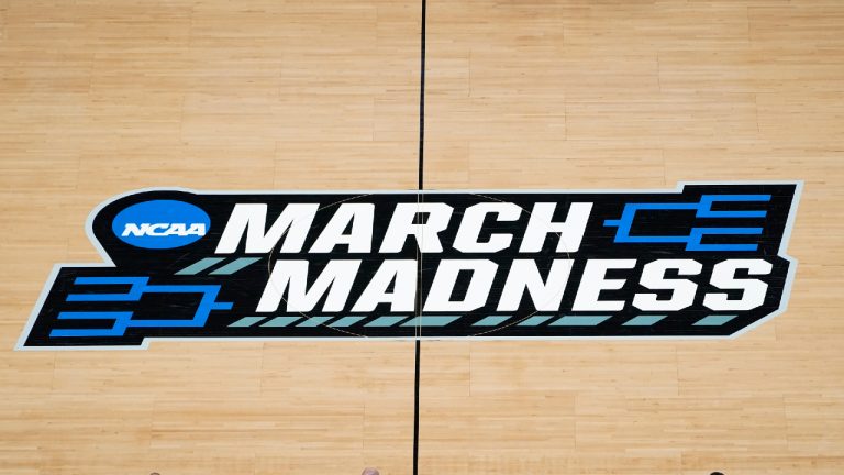 The March Madness logo is shown on the court during the first half of a men's college basketball game in the first round of the NCAA tournament at Bankers Life Fieldhouse in Indianapolis. (Paul Sancya/AP File)