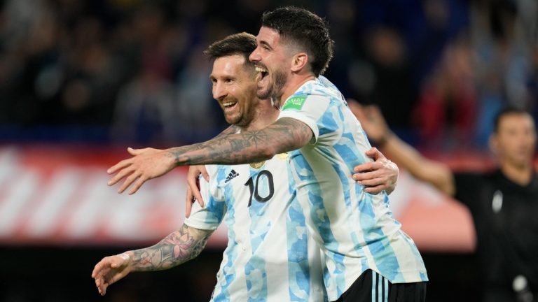Argentina's Lionel Messi, left, celebrates with his teammates Rodrigo de Paul his side's 3rd goal against Venezuela during a qualifying soccer match for the FIFA World Cup Qatar 2022, at the Bombonera stadium in Buenos Aires, Argentina, Friday, March 25, 2022.(Natacha Pisarenko/AP)