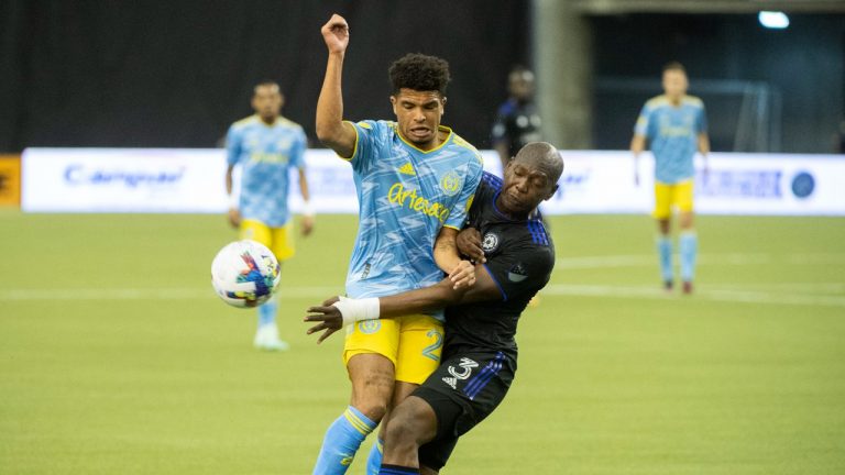 CF Montreal's Kamal Miller, right, challenges Philadelphia Union's Nathan Harriel during first half MLS soccer action in Montreal, Saturday, March 5, 2022. (Graham Hughes/CP)
