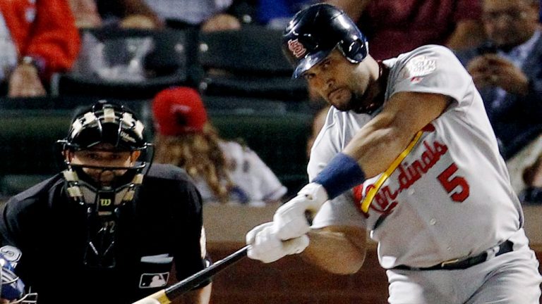 FILE - Then-St. Louis Cardinals' Albert Pujols hits a solo home run during the ninth inning of Game 3 of baseball's World Series against the Texas Rangers in Arlington, Texas, in this Saturday, Oct. 22, 2011, file photo. (Eric Gay/AP)