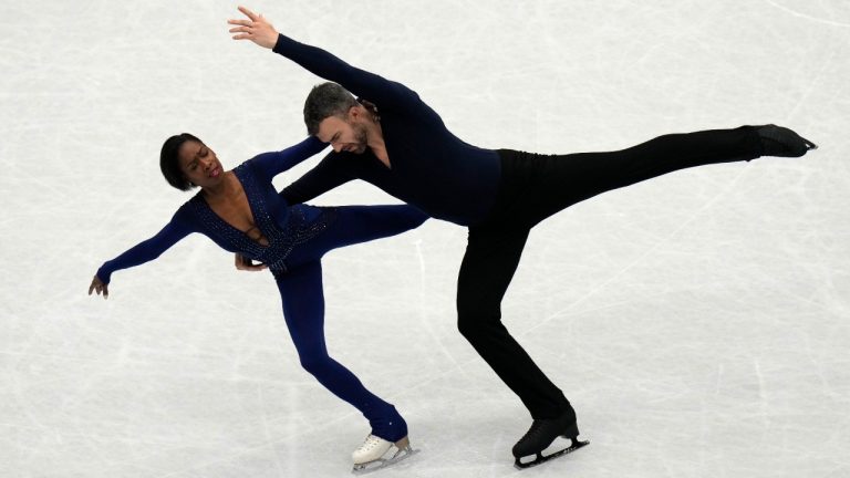 Vanessa James and Eric Radford, of Canada, perform in the pairs free program at the Figure Skating World Championships in Montpellier, south of France, Thursday, March 24, 2022. (Francisco Seco/AP)
