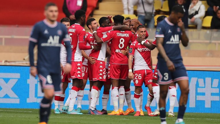 Monaco's Kevin Volland celebrates with teammates after scoring his side's second goal during the French League One soccer match between Monaco and Paris Saint-Germain at the Stade Louis II in Monaco, Sunday, March 20, 2022. (Daniel Cole/AP)