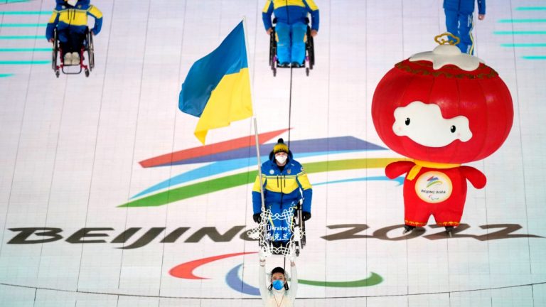 Maksym Yarovyi of Ukraine carries the flag as the team makes their entrance during the opening ceremony at the 2022 Winter Paralympics, Friday, March 4, 2022, in Beijing. (Dita Alangkara/AP)