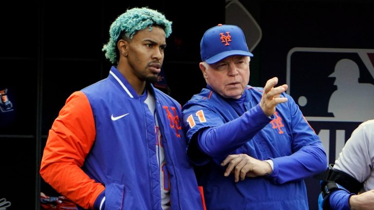 New York Mets' Francisco Lindor, left, listens as manager Buck Showalter (11) talks during the fourth inning of a baseball game against the Washington Nationals at Nationals Park, Sunday, April 10, 2022, in Washington. (Alex Brandon/AP)
