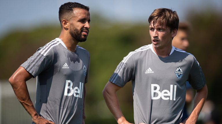 New Vancouver Whitecaps designated player Ryan Gauld, right, of Scotland, stands with Caio Alexandre during an MLS soccer club training session, in Vancouver, on Monday, August 2, 2021. (Darryl Dyck/CP)