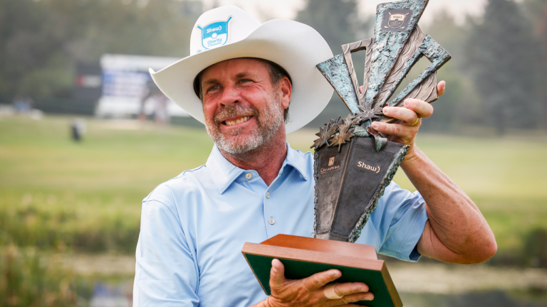 Doug Barron, right, of the United States, holds the trophy after winning the PGA Tour Champion's Shaw Charity Classic golf event in Calgary, Alta., Sunday, Aug. 15, 2021. (CP/file)