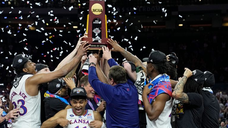 Kansas celebrates with the trophy after their win against North Carolina in a college basketball game at the finals of the Men's Final Four NCAA tournament, Monday, April 4, 2022, in New Orleans. (AP Photo/David J. Phillip)