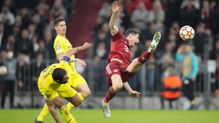 Bayern's Robert Lewandowski, right, is challenged by Villarreal's Raul Albiol during the Champions League, second leg, quarterfinal soccer match between Bayern Munich and Villareal at the Allianz Arena, in Munich, Germany, Tuesday, April 12, 2022. (AP Photo/Matthias Schrader)