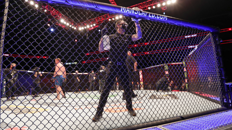 A worker wipes down the octagon between UFC bouts. (AP/file)