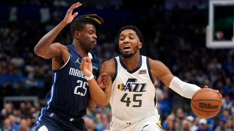 Dallas Mavericks forward Reggie Bullock (25) defends as Utah Jazz guard Donovan Mitchell (45). (Tony Gutierrez/AP)