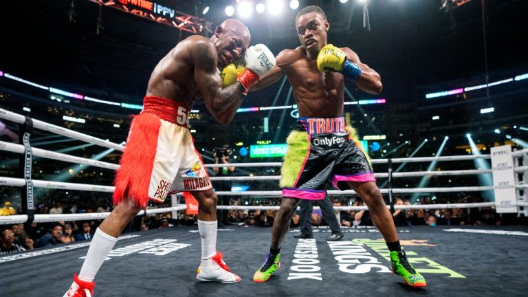 Errol Spence Jr., right, hits Yordenis Ugas, from Cuba, during a welterweight championship boxing match Saturday, April 16, 2022, in Arlington, Texas. Spence won when the fight was stopped in the 10th round. (Jeffrey McWhorter/AP)