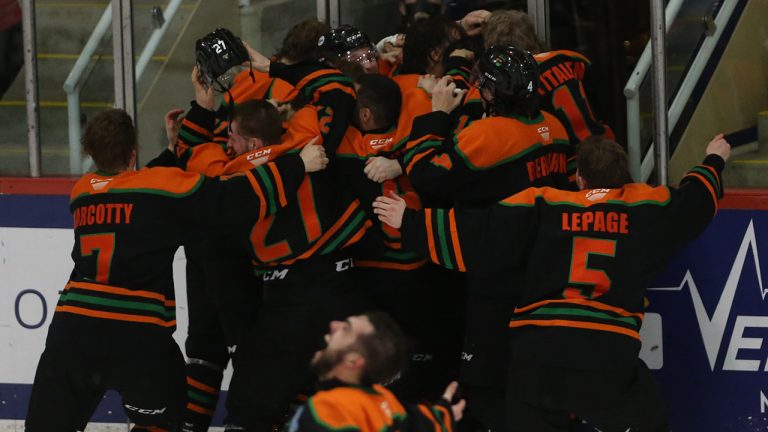 Universite du Quebec a Trois-Rivieres Patriotes mob teammate Simon Lafrance who scored in double overtime to defeat the Alberta Golden Bears during the University Cup gold medal game in Wolfville, N.S., Sunday, April 3, 2022. THE CANADIAN PRESS/Tim Krochak