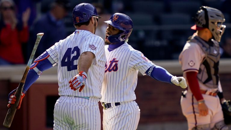 New York Mets' Francisco Lindor, centre, celebrates with Pete Alonso, left, after hitting a solo home run off Arizona Diamondbacks relief pitcher Caleb Smith in the eighth inning of a baseball game, Friday, April 15, 2022, in New York. (John Minchillo/AP Photo)