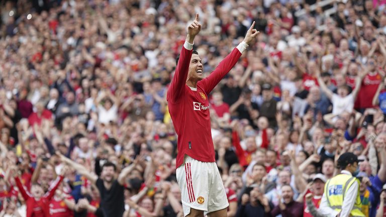 Manchester United's Cristiano Ronaldo celebrates after scoring his third goal during the English Premier League soccer match between Manchester United and Norwich City at Old Trafford stadium in Manchester. (Jon Super/AP)