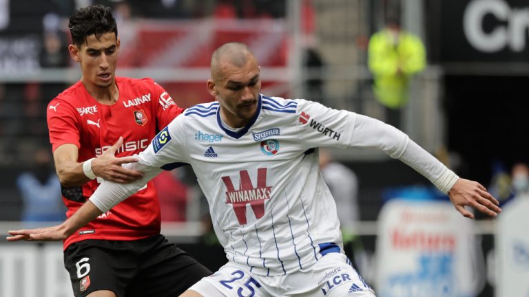 Strasbourg's Ludovic Ajorque, right, is challenged by Rennes' Nayef Aguerd during the French League One soccer match between Rennes and Strasbourg at the Roazhon Park stadium in Rennes, Germany, Sunday, Oct. 24, 2021. (Jeremias Gonzalez/AP)