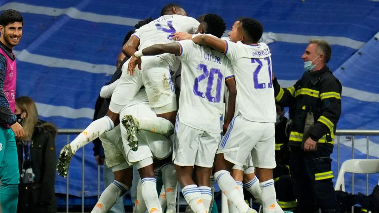 Real Madrid players celebrate after their teammate Karim Benzema scored their side's second goal during the Champions League, quarterfinal second leg soccer match between Real Madrid and Chelsea at the Santiago Bernabeu stadium. (Manu Fernandez/AP)