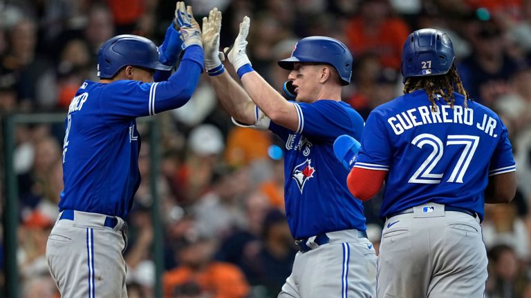 Toronto Blue Jays' Zack Collins, centre, celebrates with George Springer, left, after they and Vladimir Guerrero Jr. (27) scored on Collins' three-run home run against the Houston Astros during the sixth inning of a baseball game Sunday, April 24, 2022, in Houston. Toronto Blue Jays' Zack Collins, center, celebrates with George Springer, left, after they and Vladimir Guerrero Jr. (27) scored on Collins' three-run home run against the Houston Astros during the sixth inning of a baseball game. (David J. Phillip/AP)