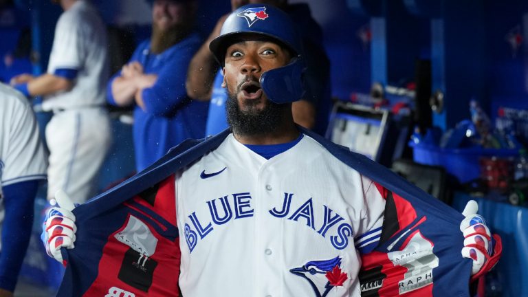 Toronto Blue Jays right fielder Teoscar Hernandez (37) reacts in the dugout after hitting a three run home run against the Texas Rangers during fifth inning home opener AL MLB baseball action in Toronto on Friday, April 8, 2022. (Nathan Denette/CP) 