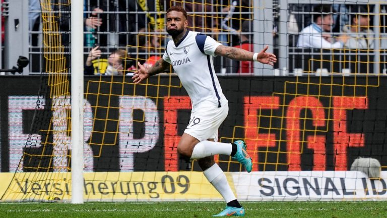 Bochum's Juergen Locadia celebrates after he scored his side's third goal during a German Bundesliga soccer match between Borussia Dortmund and VfL Bochum in Dortmund, Germany on Saturday. (Martin Meissner/AP)