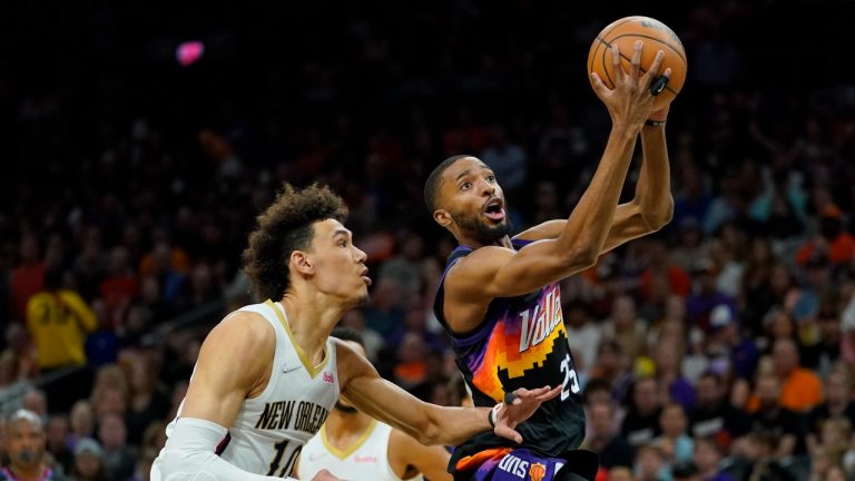 Phoenix Suns forward Mikal Bridges drives as New Orleans Pelicans center Jaxson Hayes (10) defends during the first half of Game 5 of an NBA basketball first-round playoff series, Tuesday, April 26, 2022, in Phoenix. (Matt York/AP)