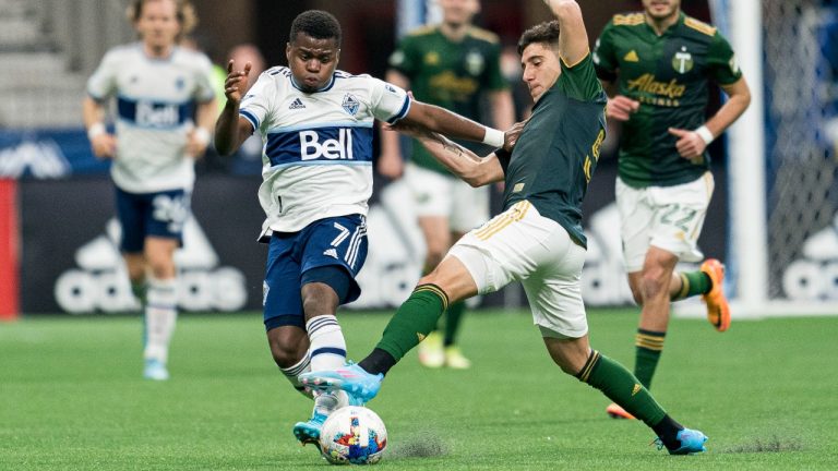 Portland Timbers defender Claudio Bravo (5) tries to breaks up the run of Vancouver Whitecaps forward Déiber Caicedo (7) during first half MLS action in Vancouver on Saturday, April 9, 2022. (Rich Lam/CP)