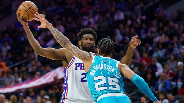 Philadelphia 76ers' Joel Embiid, left, looks to make his move against Charlotte Hornets' P.J. Washington, right, during the second half of an NBA basketball game.  (Chris Szagola/AP)