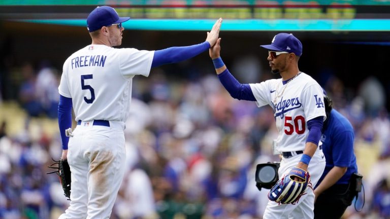Los Angeles Dodgers' Freddie Freeman (5) and Mookie Betts (50) celebrate a win over the Atlanta Braves during a baseball game Wednesday, April 20, 2022, in Los Angeles. (Marcio Jose Sanchez/AP)
