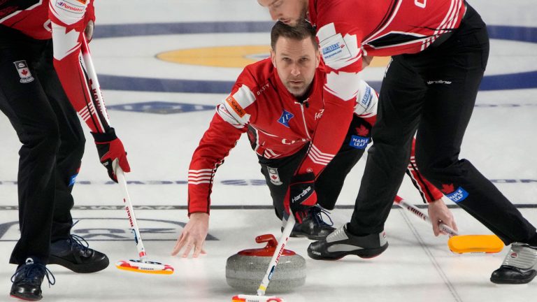 Canada Skip Brad Gushue delivers a stone against Sweden during a gold medal game at the World Men's Curling Championships. (John Locher/AP)