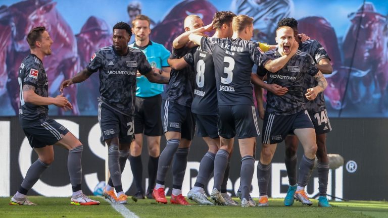 Union's Sven Michel, right, celebrates after scoring his side's second goal during the German Bundesliga soccer match between RB Leipzig and 1. FC Union Berlin in Leipzig, Germany, Saturday, April 23, 2022. (Jan Woitas/dpa via AP)