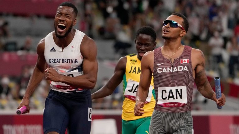 Canada's Andre De Grasse, seen here finishing behind Nethaneel Mitchell-Blake  of Great Britain at the Tokyo Games, will get a silver medal in the men's 4 x 100-metre relay after the British squad was disqualified. (Charlie Riedel/THE ASSOCIATED PRESS)