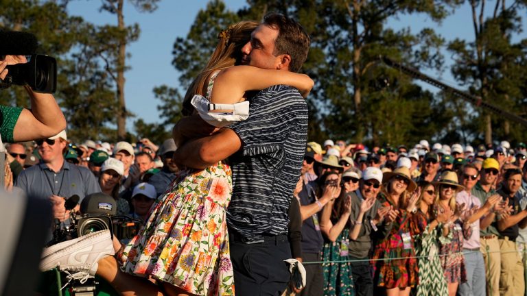 Scottie Scheffler lifts his wife Meredith Scudder off her feet after winning the 86th Masters golf tournament. (David J. Phillip/AP)