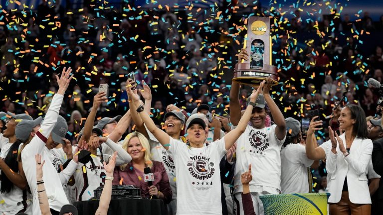 South Carolina head coach Dawn Staley celebrates with her team after a college basketball game in the final round of the Women's Final Four NCAA tournament against UConn Sunday, April 3, 2022, in Minneapolis. South Carolina won 64-49 to win the championship. (Eric Gay/AP)
