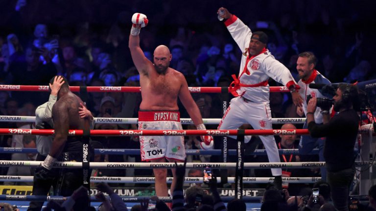 Britain's Tyson Fury, center, celebrates after beating Britain's Dillian Whyte during their WBC heavyweight title boxing fight at Wembley Stadium. (Ian Walton/AP)