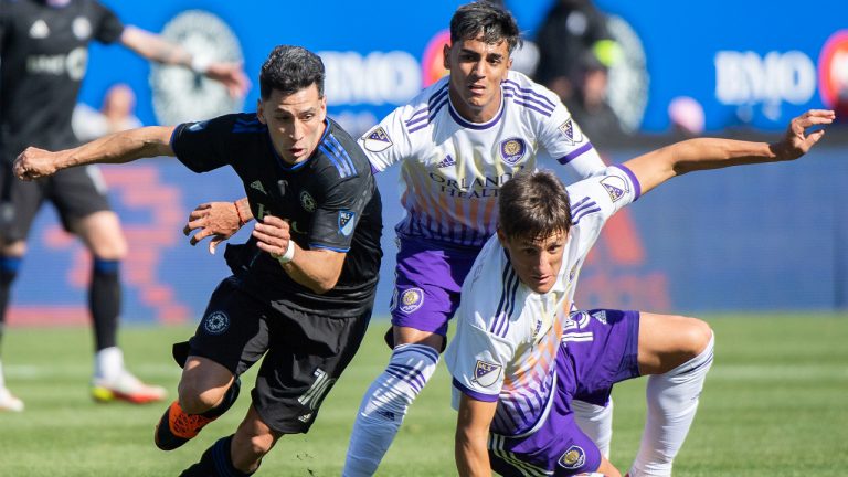 CF Montreal's Joaquin Torres, left, breaks away from Orlando City's Rodrigo Schlegel, right, during first half MLS soccer action in Montreal, Saturday, May 7, 2022. (Graham Hughes/CP)