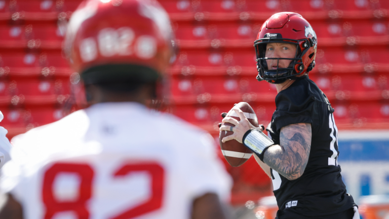 Calgary Stampeders quarterback Bo Levi Mitchell, right, looks to Malik Henry during opening day of the CFL team's training camp in Calgary, Sunday, May 15, 2022. (CP)