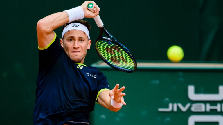 Casper Ruud of Norway returns a ball to Thanasi Kokkinakis of Australia during their quarter-final match, at the ATP 250 Geneva Open Tennis tournament in Geneva, Switzerland, Thursday, May 19, 2022. (Jean-Christophe Bott/AP)