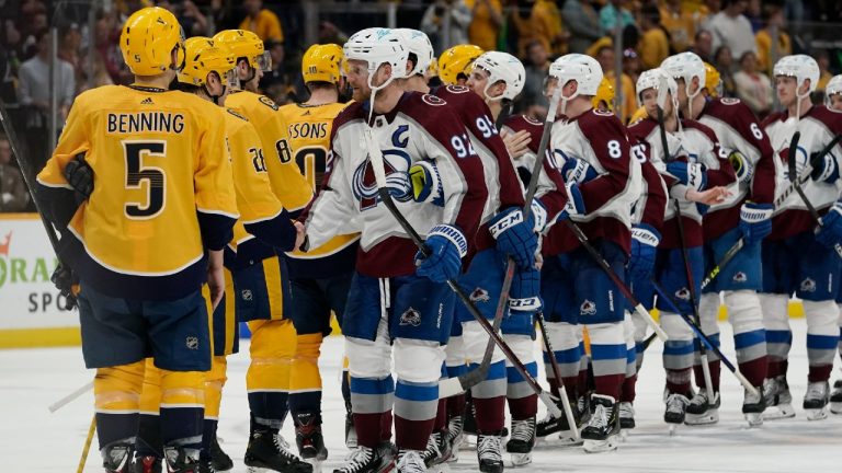 Colorado Avalanche left wing Gabriel Landeskog (92) leads the Avalanche as they shake hands with the Nashville Predators after Game 4 of an NHL hockey first-round playoff series Monday, May 9, 2022, in Nashville, Tenn. (Mark Humphrey/AP)