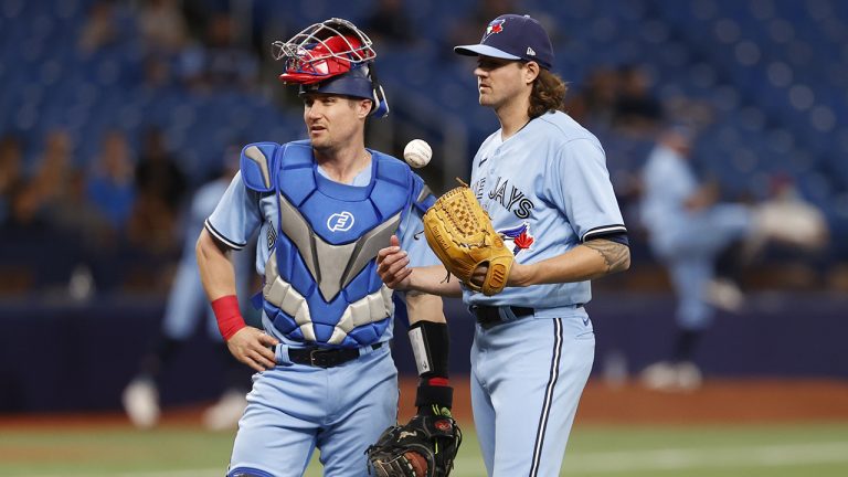 Toronto Blue Jays starting pitcher Kevin Gausman, right, stands on the mound with catcher Zack Collins while play was being reviewed during the eighth inning of a baseball game against the Tampa Bay Rays. (Scott Audette/AP)