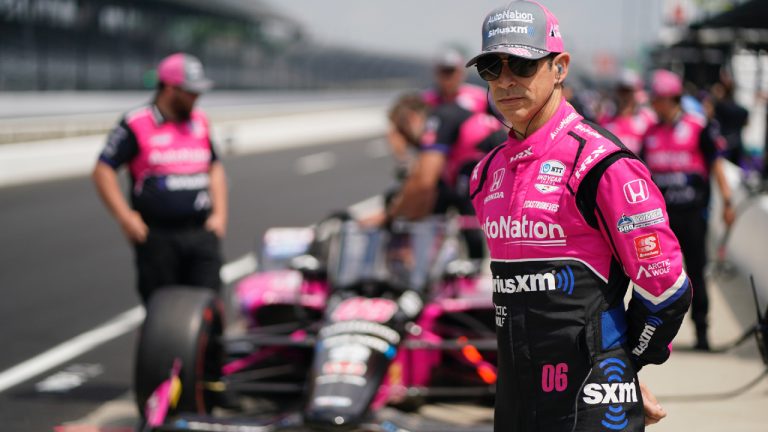 Helio Castroneves, of Brazil, stands in fron of his car during practice for the Indianapolis 500 auto race at Indianapolis Motor Speedway, Thursday, May 19, 2022, in Indianapolis. (Darron Cummings/AP)