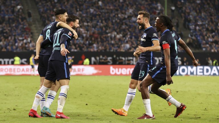 Hertha players celebrate after avoiding relegation from the Bundesliga, after the German Bundesliga relegation/promotion playoff soccer match between Hamburger SV and Hertha Berlin at the Volksparkstadion in Hamburg, Germany, Monday, May 23, 2022. Hertha Berlin has taken its final chance to clinch Bundesliga survival with a 2-0 win at Hamburger SV in the second leg of their relegation/promotion playoff. (Gregor Fischer/dpa via AP)