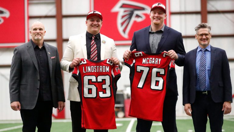 Atlanta Falcons NFL football coach Dan Quinn, left, poses with Falcons' first-round-draft picks Chris Lindstrom, (63), of Boston College, Kaleb McGary (76), from Washington, and general manger Thomas Dimitroff, right, Friday, April 26, 2019, in Flowery Branch, Ga. Lindstrom and McGary are both offensive linemen. (John Bazemore/AP)